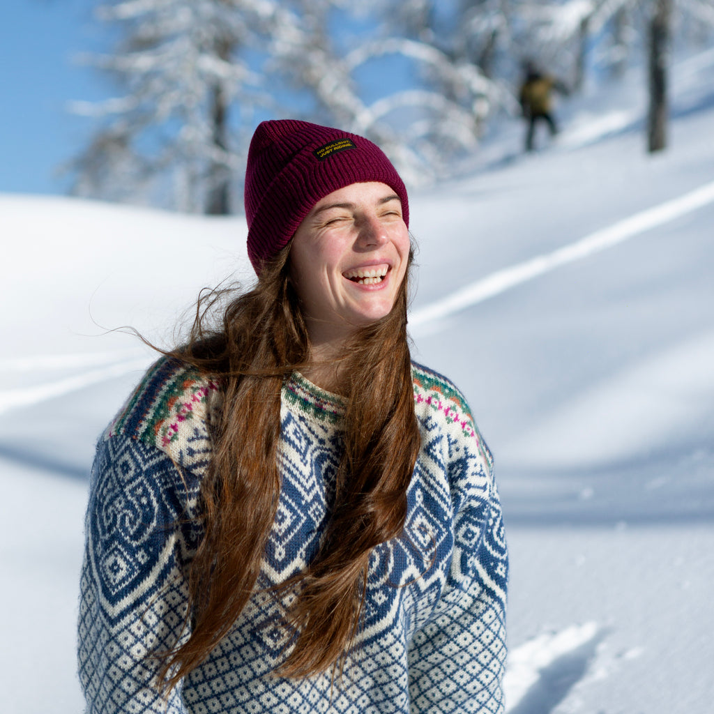 Discover our Adult Classic Beanie—100% acrylic, snug fit, perfect for snowboarding, skiing, and cold-weather wear. Available in vibrant colors with the "No bullshit, just riding" label. Stay warm and stylish on every winter adventure. Ideal for adults who love bold style! Model. NGtool best multitool, binding tool on Snow. Beauty burgundy color on Model on Snow.