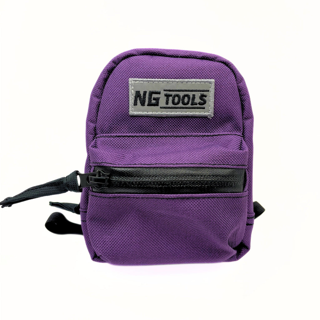 Purple NG binding snowboard bag attached to a snowboard binding high-back, compact and lightweight gear for snowboarders, designed for secure storage during snowboarding adventures.