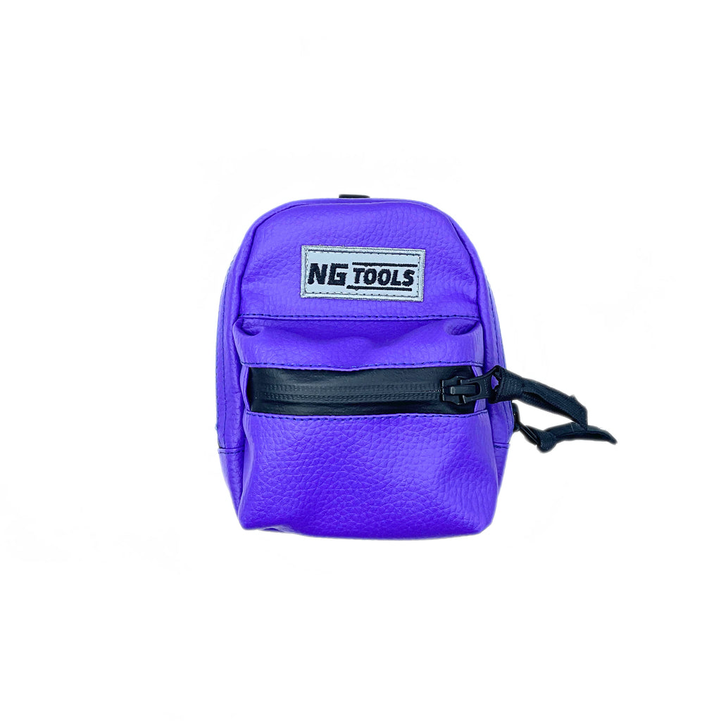 NG Snowboard Binding Bag in Purple leather, securely attached to a snowboard binding. High-back snowboard backpack for carrying tools, wax, or essentials while riding.